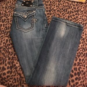 blinged out & distressed miss me boot cut jeans .